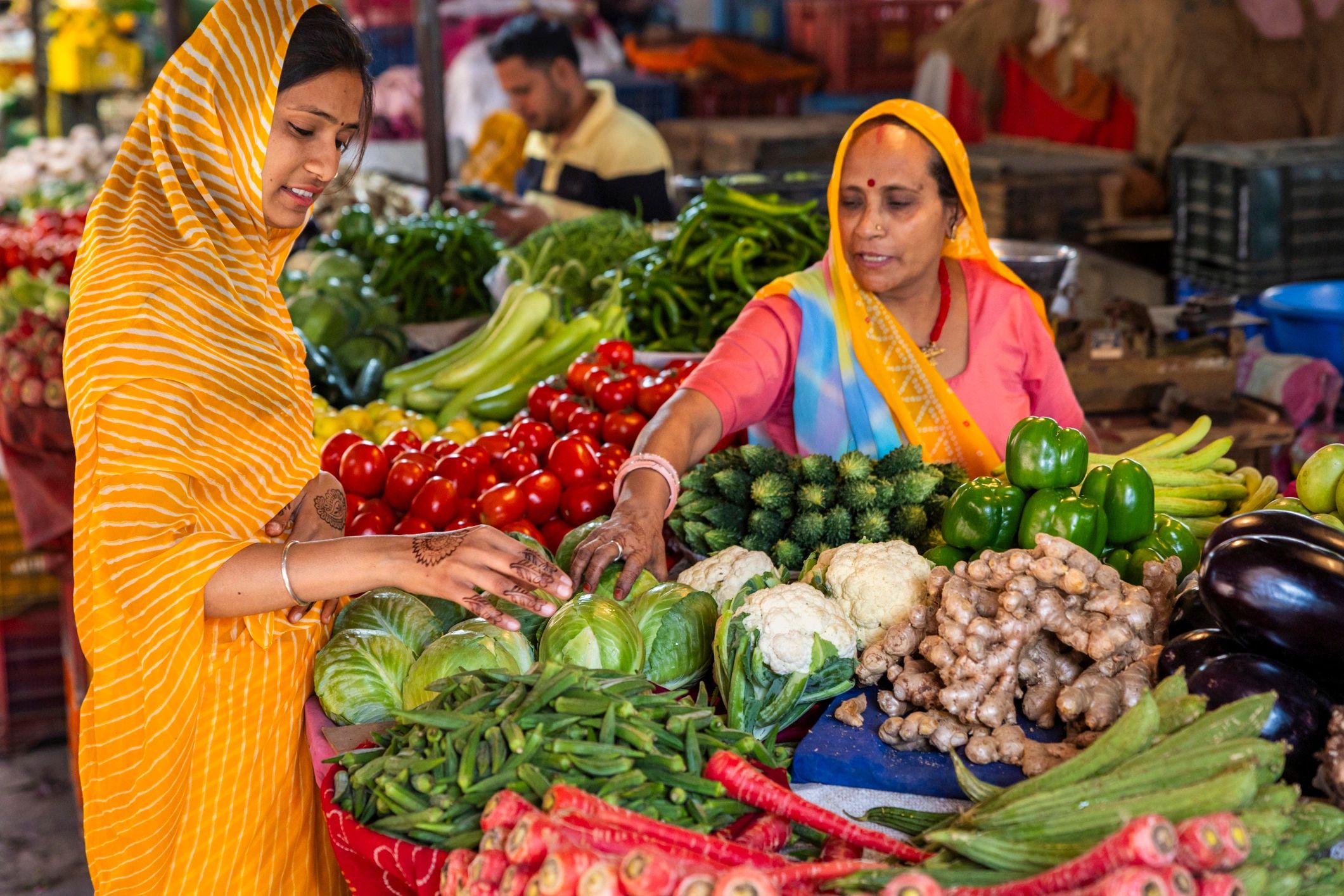 Customers selecting fresh vegetables at a local market